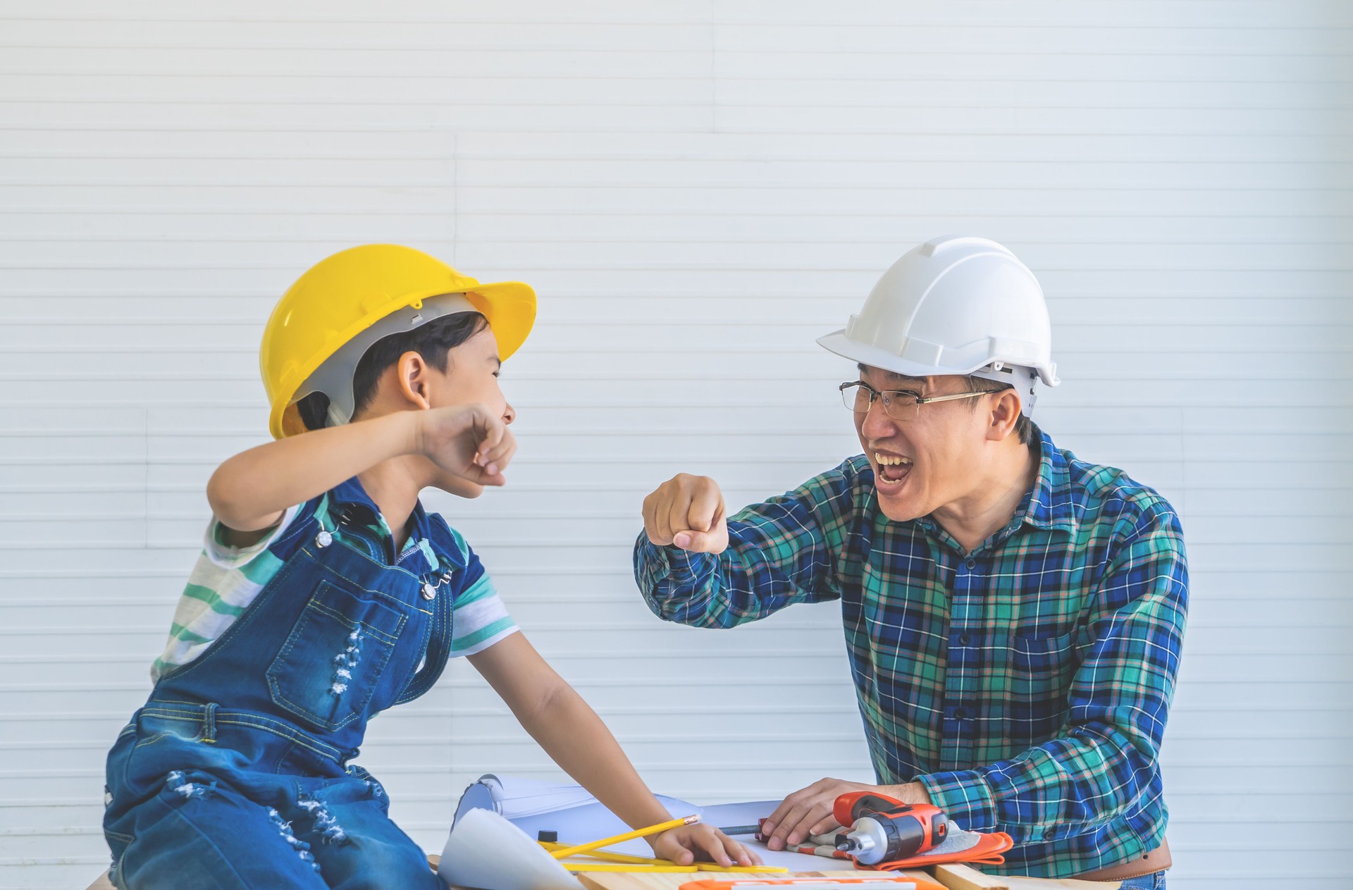 Father and Son fist bump for success concept in construction industry concept.